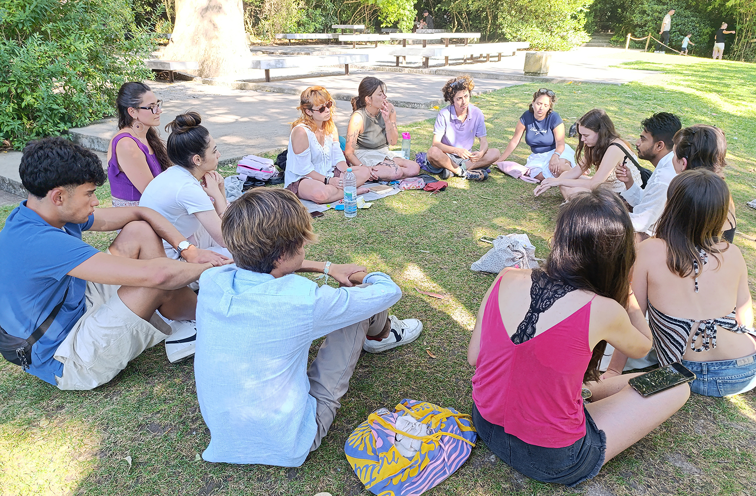 TDFF and SPIN volunteers hold an outdoor interview circle, discussing their experiences, cultural exchange, and personal growth during their volunteering journey.