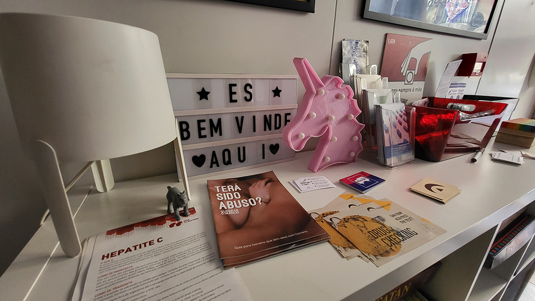Information desk of ILGA Portugal with brochures and support materials for the LGBTQ+ community.